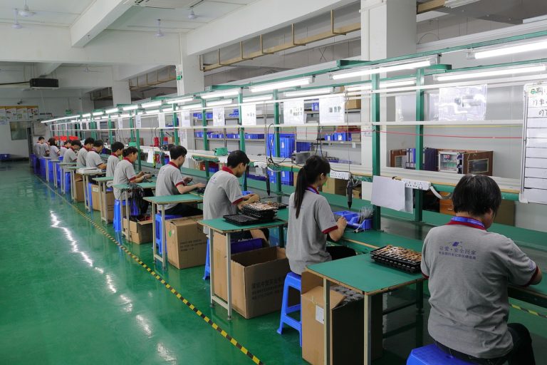 A line of Staff are working in the factory